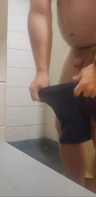Taking a shower in a public shower.
