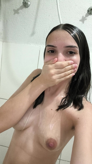 Brunette takes a shower and shaves