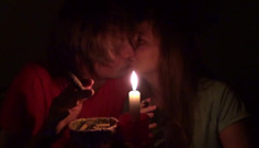Couple smoke next to candle