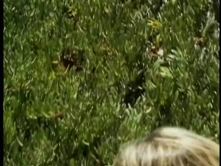 Tan, blonde lesbians toy each others pussies in the sand dunes