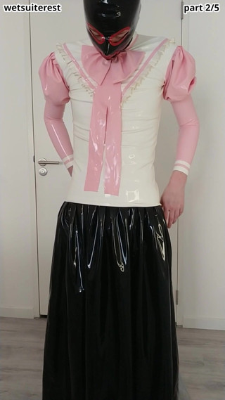 Putting on pink frilly latex blouse over long rubber skirt, maid stockings, transparent panties, layers thumbnail