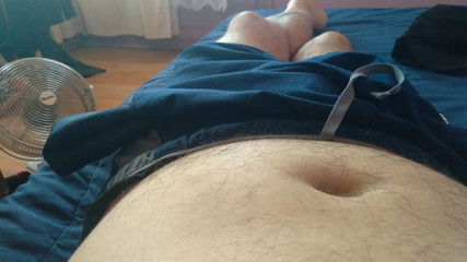 gay man giving an amateur massage to his huge penis