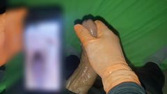 masturbating in pleasure watching video of women on cell phone screen on the internet