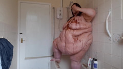 Ssbbw body covered in chocolate sauce in shower