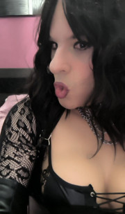 Crossdresser masturbating in high boots and leather gloves