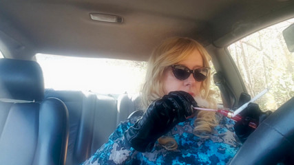 Mature Blonde GILF smoking long cigarettes while driving her car thumbnail