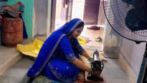 Indian wife sewing on the machine but she has other thoughts too.