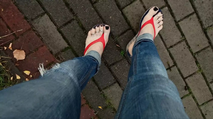 a crossdresser with sexy feet in flip flops is tempting on the street thumbnail