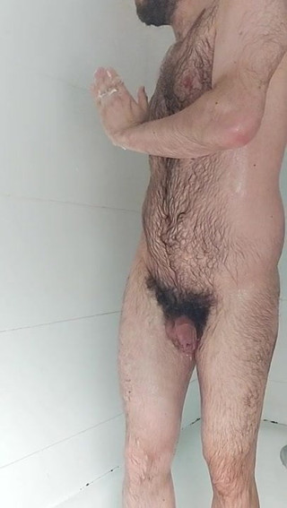 Hairy boy showers and locks up his cock