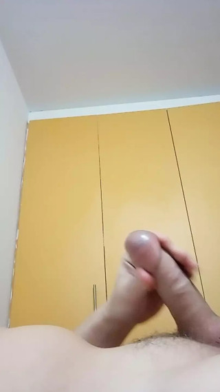 A young but very handsome guy plays catch-up with his cute cock