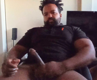 Thick mixed Latino bear jacks off to porn