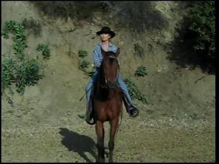 Young beautiful blonde was riding the horse when she has  met handsome cowboy