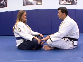 Judoka shows blonde what exercise he does at home