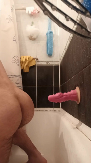 guy fucks himself with a dragon dildo in the shower