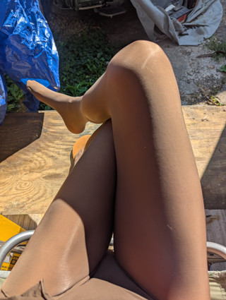 Crossdresser suntanning in black pantyhose thumbnail