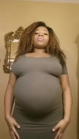 Pregnant ebony belly rub