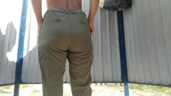 Tanned slim beauty changing clothes on the beach in the locker room