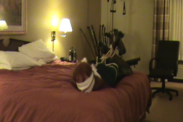 Hogtied, gagged, and blindfolded crossdresser