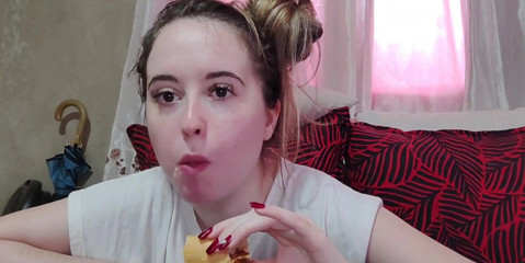 Eating an omelette sandwich with cherry tomatoes
