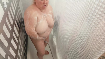 Mother-in-law takes a shower and washes her big tits