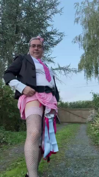 Dressed in a small pink skirt and a Hello Kitty tie for an evening. thumbnail