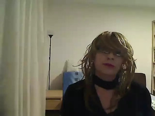 horny MILF tranny in front of the camera simulates a Blowjob while playing with a vibrator