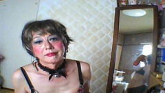 The cross-dresser puts a glass ball in her anus and writhes.