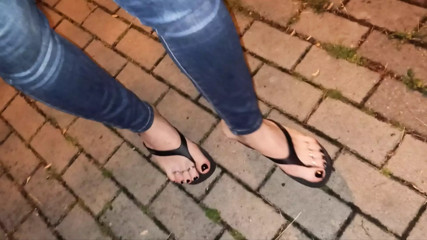 a crossdresser with beautiful feet walks the street and seduces in sexy flip-flops thumbnail