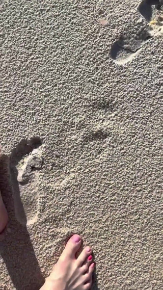 Comparing Size 16 Feet to Sand Prints at the Beach