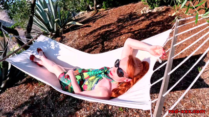 Red XXX stuffs her pussy with a toy in the hammock
