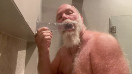 DaddybearAZ deep throats a dildo in the shower