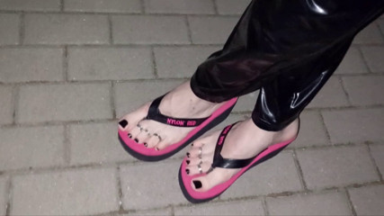 crossdresser in sexy flip-flops and latex leggings thumbnail