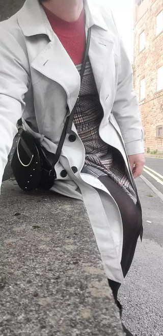 Crossdressing slut exposes her caged cock on public street