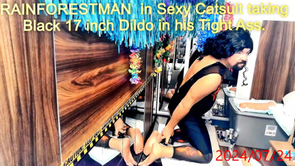 RAINFORESTMAN in Catsuit taking Black 17 inch Dildo in his Tight Ass.