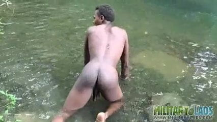 Brown soldier strips naked by the stream