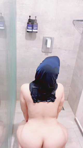Indonesian girl taking a shower in traditional clothes