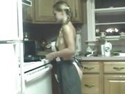 Slutty chick pokes her cunt with kitchen utensils on counter