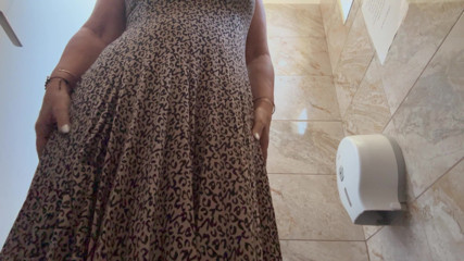 A horny mature MILF is very aroused and is rubbing her pussy in the public restroom at the office.