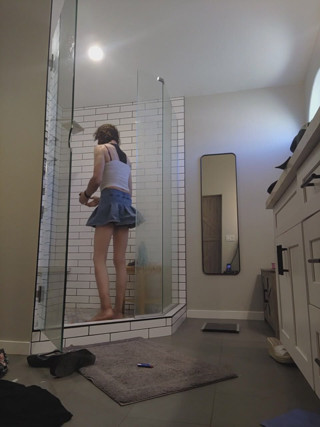 In the bathroom trying on different outfits getting wet and smoking