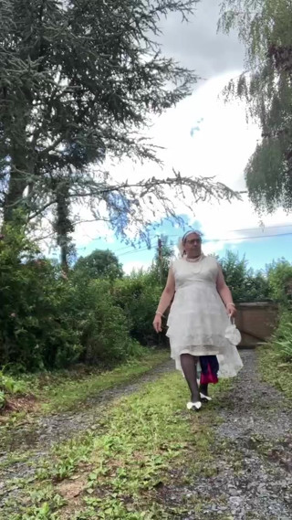 In an outfit with a long white dress for an evening. thumbnail