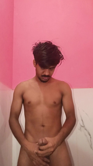 The boy is caressing his penis in the bathroom