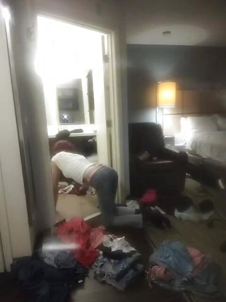 Looking through some clothes on hands and knees