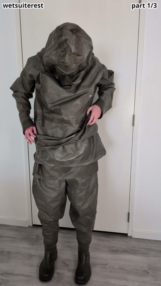 Putting on Zodiac Zodiak heavy rubber hazmat suit over plastic pants and gas mask