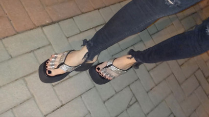 I wear platform flip-flops and tight jeans, showing off my feet. thumbnail