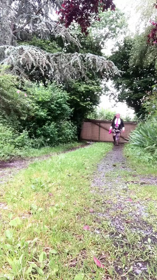 In a little floral skirt and fuchsia tie with stains in the garden for an evening